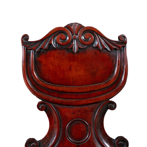 25 - A VICTORIAN MAHOGANY HALL CHAIR,  with scroll framed shield shaped back, over panelled seat, on turn... 