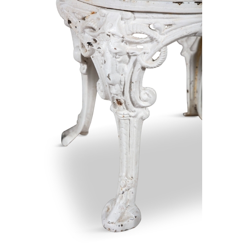 3 - A VICTORIAN WHITE PAINTED CAST IRON GARDEN TABLE AND TWO CHAIRS,  the chairs with arched pierced bac... 