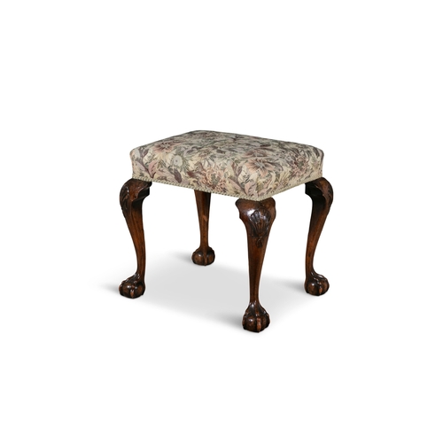 34 - AN IRISH CARVED MAHOGANY STOOL, C.1900  the rectangular padded seat, raised on shell capped cabriole... 