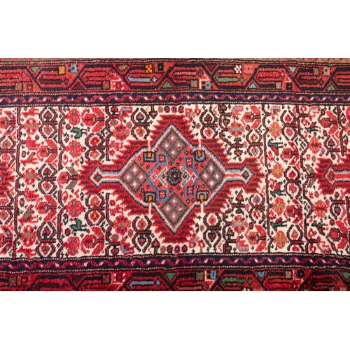 52 - AN IRANIAN RUNNER, 275 x 82cm  the central field woven with three diamond lozenges, in red tones, ag... 