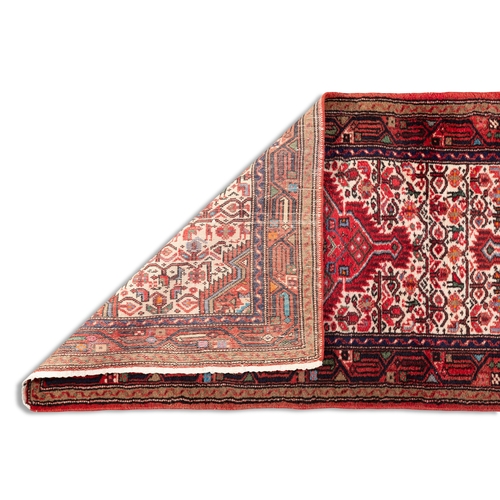 52 - AN IRANIAN RUNNER, 275 x 82cm  the central field woven with three diamond lozenges, in red tones, ag... 