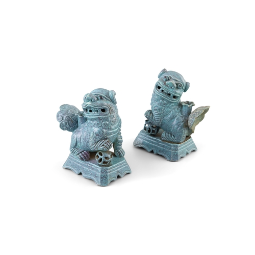 138 - A PAIR OF ROBIN'S EGG-GLAZED BUDDHISTIC LION INCENSE HOLDERS  民国 炉均釉獅子瓷塑香插一對  China, Republic period... 