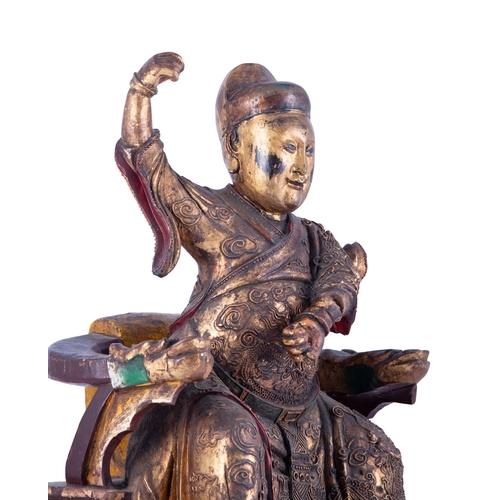 152 - A GILT AND POLYCHROME PAINTED TAOIST GUARDIAN SEATED FIGURE  清早 木泥金彩繪道教護法坐像  China, early Qing dynas... 