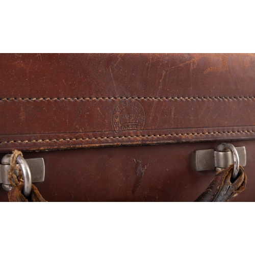 20 - A LEATHER TRAVEL SUITCASE, EARLY 20TH CENTURY,  with remnants of 'Tramore, Waterford' travel label. ... 