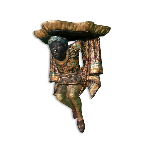 27 - A POLYCHROME CARVED WOOD WALL BRACKET IN THE FORM OF A MALE BLACKAMOOR,   supporting a bowfront gild... 