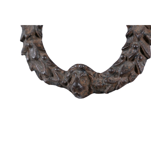 29 - A 19TH CENTURY CAST IRON DOOR KNOCKER,   formed as a clenched hand suspending a laurel wreath with l... 