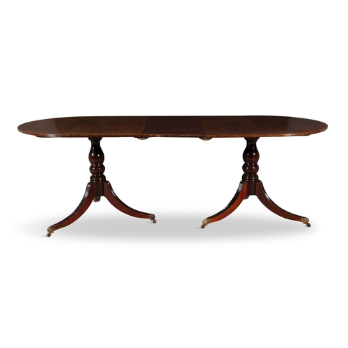 329 - A REGENCY STYLE MAHOGANY TWIN PILLAR DINING TABLE, EARLY 19TH CENTURY  with rounded ends and reeded ... 