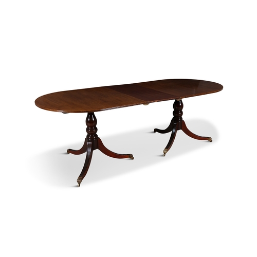 329 - A REGENCY STYLE MAHOGANY TWIN PILLAR DINING TABLE, EARLY 19TH CENTURY  with rounded ends and reeded ... 