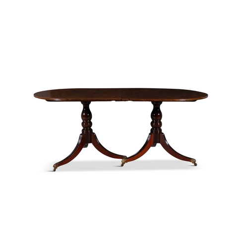 329 - A REGENCY STYLE MAHOGANY TWIN PILLAR DINING TABLE, EARLY 19TH CENTURY  with rounded ends and reeded ... 