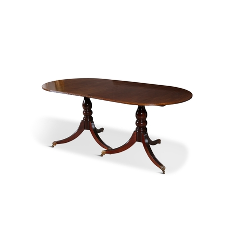 329 - A REGENCY STYLE MAHOGANY TWIN PILLAR DINING TABLE, EARLY 19TH CENTURY  with rounded ends and reeded ... 