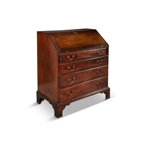 330 - A GEORGE III MAHOGANY SLOPE FRONT BUREAU   the crossbanded sloped front panel enclosing a tooled lea... 