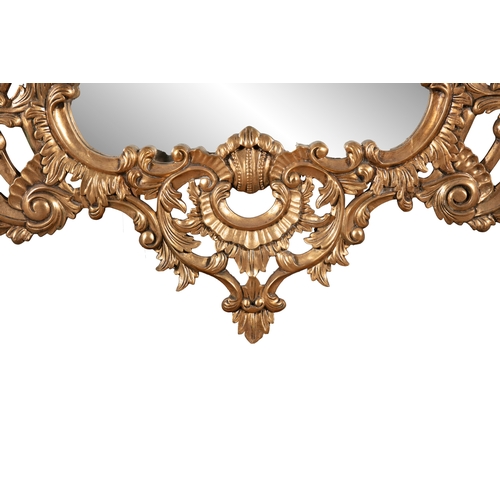 51 - A LARGE VICTORIAN STYLE GILTWOOD WALL MIRROR,   20th century, fitted with shaped rectangular plate, ... 