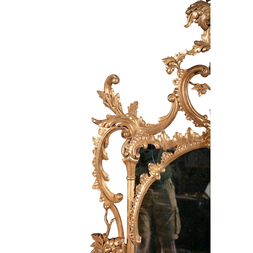 52 - A ROCOCO STYLE GILTWOOD MIRROR,   20th century, fitted with plain oval plate, enclosed by a pierced ... 