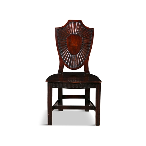 65 - A PAIR OF GEORGE III MAHOGANY SHIELD BACK HALL CHAIRS   each solid panel back with inlaid crest and ... 