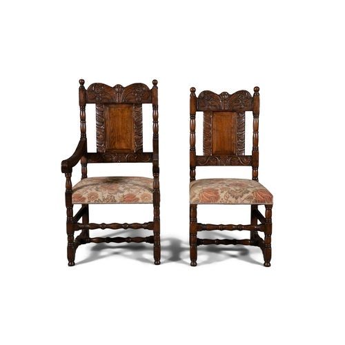 66 - TWO 17TH CENTURY STYLE CARVED OAK ARMCHAIRS   the shaped rectangular backs with floral scroll work c... 