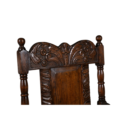 66 - TWO 17TH CENTURY STYLE CARVED OAK ARMCHAIRS   the shaped rectangular backs with floral scroll work c... 