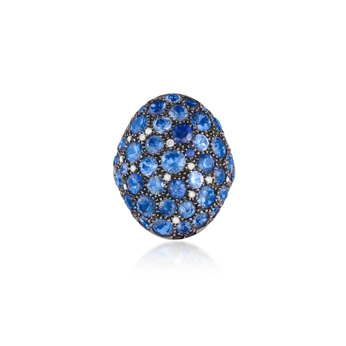 110 - A SAPPHIRE AND DIAMOND DRESS RING  Of oval bombé design, pavé-set with circular-cut sapphires with b... 