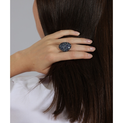 110 - A SAPPHIRE AND DIAMOND DRESS RING  Of oval bombé design, pavé-set with circular-cut sapphires with b... 