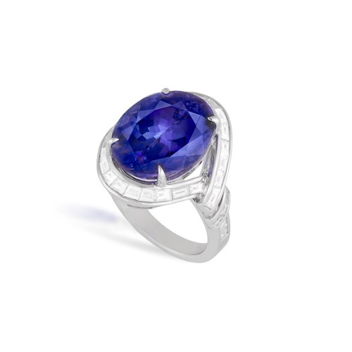 111 - A TANZANITE AND DIAMOND DRESS RING  The oval-shaped tanzanite weighing approximately 14.50cts within... 