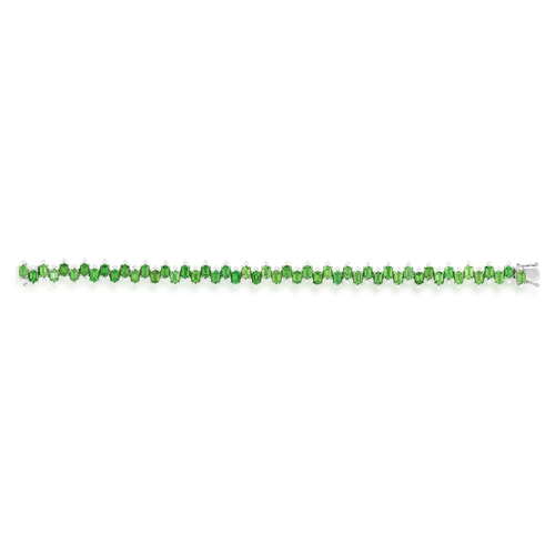 114 - A TSAVORITE GARNET AND DIAMOND BRACELET  Composed of a continuous juxtaposed line of rectangular-cut... 