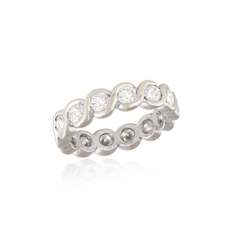 115 - A DIAMOND ETERNITY RING  The continuous row of brilliant-cut diamonds within swirling collet-setting... 