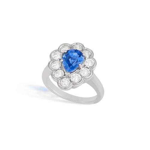 118 - A SAPPHIRE AND DIAMOND CLUSTER RING  The pear-shaped sapphire within a brilliant-cut diamond scallop... 