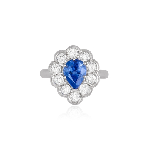 118 - A SAPPHIRE AND DIAMOND CLUSTER RING  The pear-shaped sapphire within a brilliant-cut diamond scallop... 