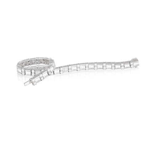 125 - A DIAMOND LINE BRACELET  Composed of a series of channel-set baguette-cut diamonds, interspersed wit... 