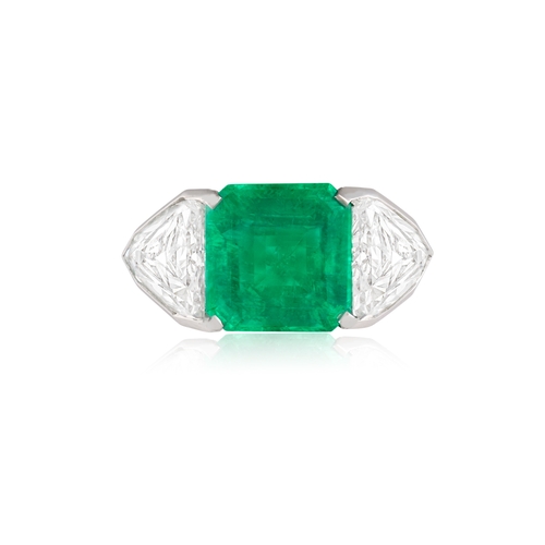 127 - LANGI: AN IMPRESSIVE EMERALD AND DIAMOND RING  Centring an octagonal step-cut emerald weighing 4.36c... 