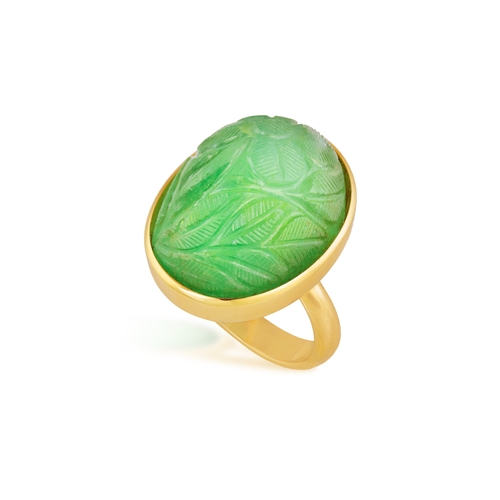 135 - AN EMERALD RING  Of foliate design, the oval-shaped carved cabochon emerald weighing approximately 3... 