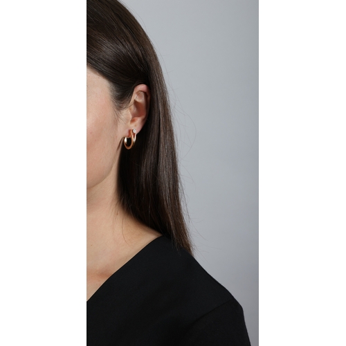 143 - REPOSSI: A DIAMOND 'SERTI INVERSÉ' EARRING  Of openwork loop design, set with a pear-shaped diamond,... 