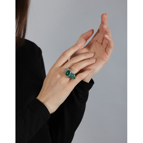 150 - AN EMERALD AND DIAMOND DRESS RING  The central oval-shaped emerald cabochon weighing approximately 5... 