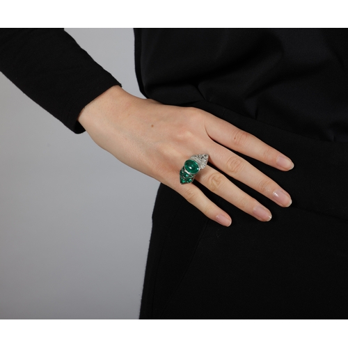 150 - AN EMERALD AND DIAMOND DRESS RING  The central oval-shaped emerald cabochon weighing approximately 5... 