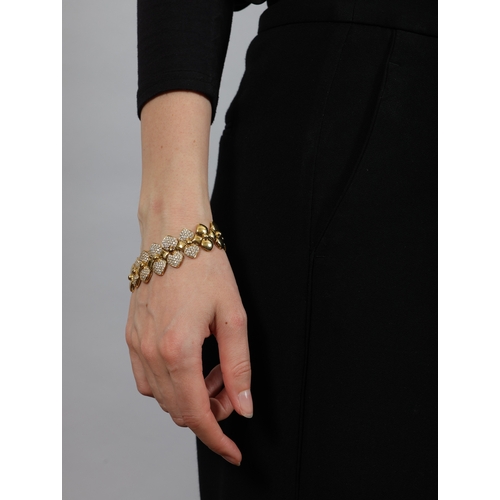 157 - A DIAMOND BRACELET  The highly articulated bracelet with polished links and beaded detailing, centri... 