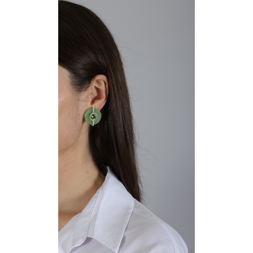 162 - MARGHERITA BURGENER: A PAIR OF JADE, PERIDOT AND DIAMOND EARRINGS  Each polished circular plaque set... 