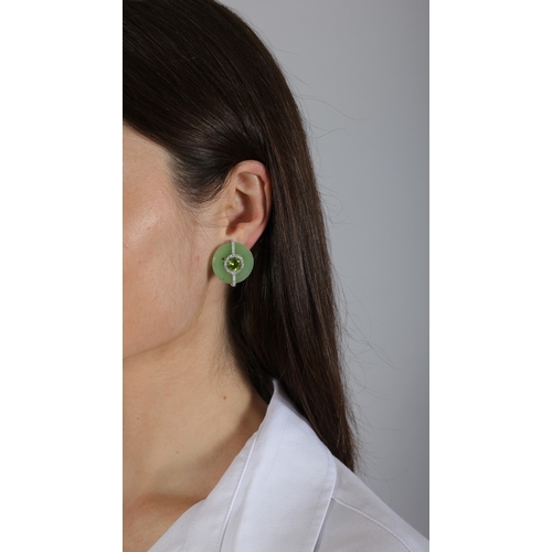 162 - MARGHERITA BURGENER: A PAIR OF JADE, PERIDOT AND DIAMOND EARRINGS  Each polished circular plaque set... 