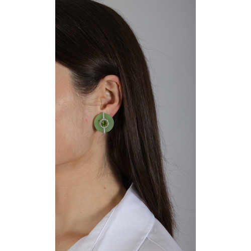 162 - MARGHERITA BURGENER: A PAIR OF JADE, PERIDOT AND DIAMOND EARRINGS  Each polished circular plaque set... 