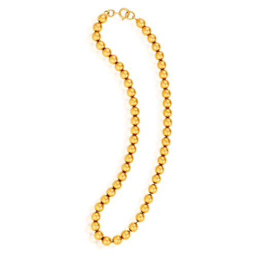 174 - A GOLD BEAD NECKLACE  Composed of a fancy-link chain suspending a series of gold beads throughout, i... 