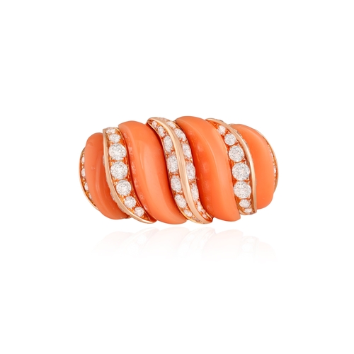 178 - A CORAL AND DIAMOND RING  Of bombé design, the carved coral interspersed with brilliant-cut diamonds... 