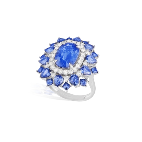 187 - A SAPPHIRE AND DIAMOND CLUSTER RING  The elongated oval-shaped sapphire within a four-claw setting, ... 