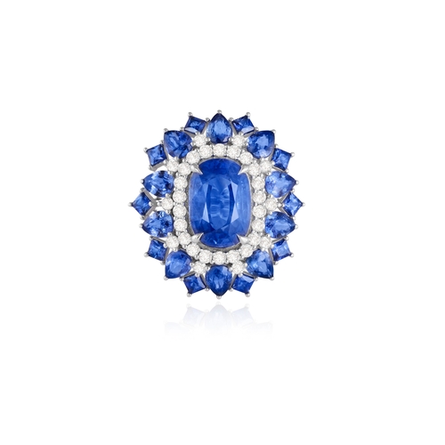 187 - A SAPPHIRE AND DIAMOND CLUSTER RING  The elongated oval-shaped sapphire within a four-claw setting, ... 