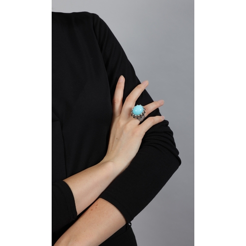 189 - A TURQUOISE AND DIAMOND COCKTAIL RING  Set with an oval-shaped turquoise cabochon at the centre with... 