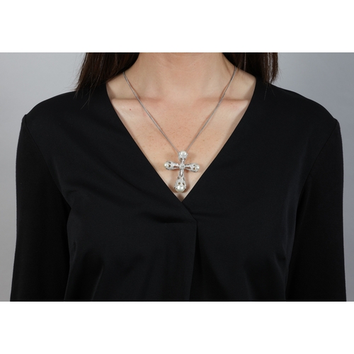 194 - A CULTURED PEARL AND DIAMOND PENDANT ON CHAIN  Of openwork cross design, centring a pear-shaped diam... 