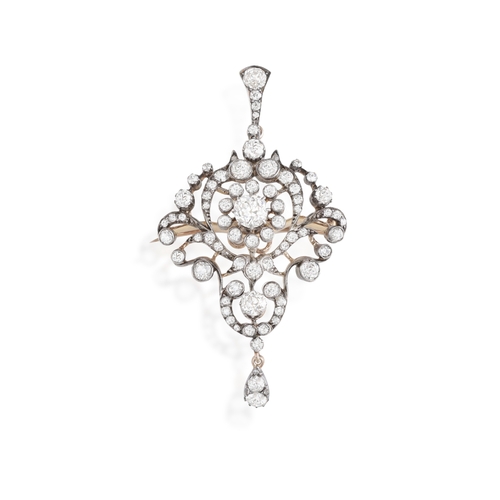 20 - A LATE 19TH/EARLY 20TH CENTURY DIAMOND PENDANT/BROOCH  Of openwork scrolling foliate design, set thr... 