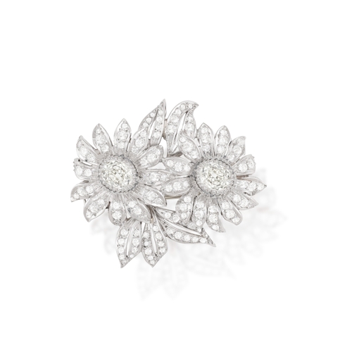 205 - A DIAMOND FLOWER BROOCH  Composed of two flowerhead, each centring an old cushion-shaped diamonds, t... 