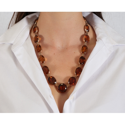 25 - AN IMPORTANT LATE 19TH CENTURY RIVIÈRE NECKLACE, CIRCA 1880  Centring a circular-cut citrine weighin... 