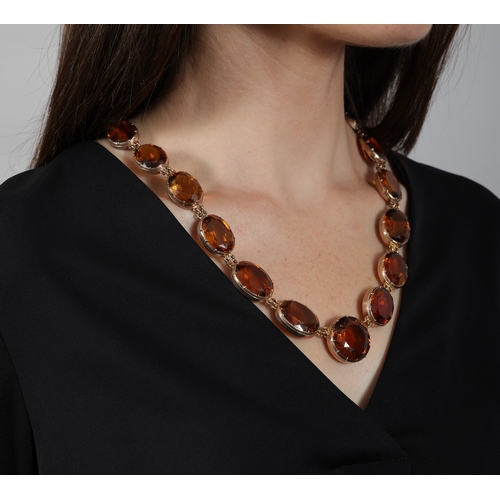 25 - AN IMPORTANT LATE 19TH CENTURY RIVIÈRE NECKLACE, CIRCA 1880  Centring a circular-cut citrine weighin... 