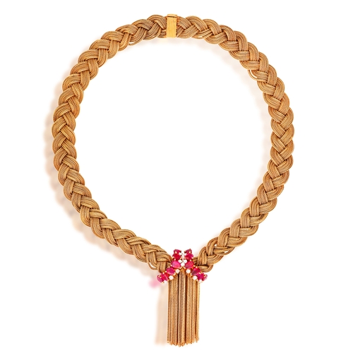 39 - A RUBY AND DIAMOND NECKLACE, CIRCA 1955  Designed as a braided gold lariat, set with pear-shaped rub... 