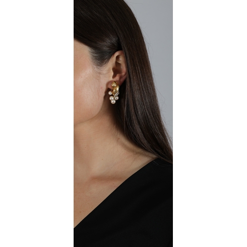 41 - M. GÉRARD: A PAIR OF CULTURED PEARL AND DIAMOND EARCLIPS  Each twisted textured gold surmount, highl... 