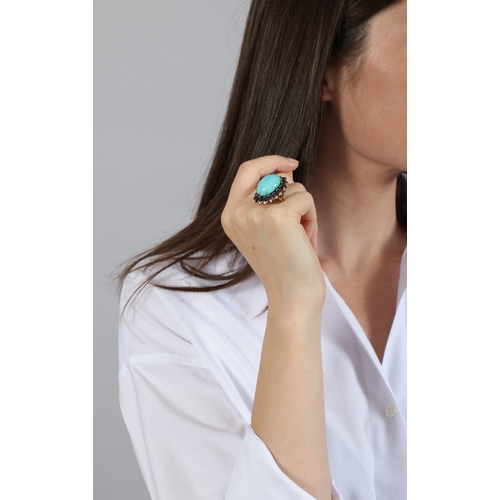 61 - A TURQUOISE, SAPPHIRE AND DIAMOND DRESS RING, FRENCH  Set with an oval-shaped turquoise cabochon at ... 